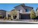 Contemporary home featuring a two-car garage, desert landscaping, and a modern architectural design at 12452 Lincoln Creek Ave, Las Vegas, NV 89138