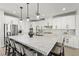 Spacious kitchen with large center island, designer lighting, stainless steel appliances, and marble countertops at 12452 Lincoln Creek Ave, Las Vegas, NV 89138