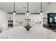 Close-up view of the kitchen island featuring a white countertop and crystal pendant lighting at 12452 Lincoln Creek Ave, Las Vegas, NV 89138