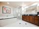 Bright bathroom featuring a bathtub, a glass shower, and a vanity with dark wood cabinets at 145 E Harmon Ave # 2007, Las Vegas, NV 89109