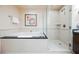 Bright bathroom featuring a bathtub, shower, and vanity, all finished with light tile at 145 E Harmon Ave # 2007, Las Vegas, NV 89109