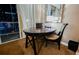 Dining area with a table and chairs, with city lights visible from the window at 145 E Harmon Ave # 2007, Las Vegas, NV 89109