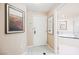 A bright foyer with tile flooring and artwork, leading to a bathroom with a soaking tub at 145 E Harmon Ave # 2007, Las Vegas, NV 89109