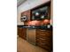 Well-equipped kitchenette with microwave, mini-fridge, dark wood cabinets and drawers, and black countertop at 145 E Harmon Ave # 2007, Las Vegas, NV 89109