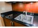 Close up of the modern kitchenette featuring a stainless steel sink and black counter top cooktop at 145 E Harmon Ave # 2007, Las Vegas, NV 89109