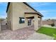 Exterior view of the house with a covered patio and a block wall at 1485 Sound Ln, North Las Vegas, NV 89031