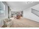 Open concept living room, dining area, and kitchen with neutral carpet and lots of natural light at 1485 Sound Ln, North Las Vegas, NV 89031