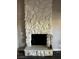 Close up of a fireplace with stone masonry around it, with hard wood floors at 1639 Justin Cir # 1639, Henderson, NV 89011