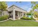 A beautiful backyard complete with green turf, mature landscaping, and covered patio at 181 Cliff Valley Dr, Las Vegas, NV 89148