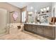 Luxurious bathroom featuring double vanity, soaking tub, and a glass-enclosed shower at 181 Cliff Valley Dr, Las Vegas, NV 89148