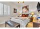 Cozy bedroom featuring large windows, natural light, a bench, and bedside table at 181 Cliff Valley Dr, Las Vegas, NV 89148