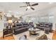 Open-concept living area with wood floors, ceiling fan, and plantation shutters, blending comfort and style at 181 Cliff Valley Dr, Las Vegas, NV 89148