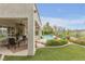 Covered patio with ceiling fan, outdoor seating, and mature landscaping at 181 Cliff Valley Dr, Las Vegas, NV 89148