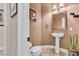 Cozy powder room featuring pedestal sink, framed mirror, and stylish fixtures at 181 Cliff Valley Dr, Las Vegas, NV 89148