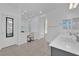 Well-lit bathroom boasting tile floors, double sinks, vanity with a chair, and a large mirror with modern lighting at 227 Badwater Basin St, Las Vegas, NV 89138