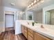 Bright bathroom featuring double vanity, modern lighting, walk-in shower and wood-look floors at 2325 Windmill Pkwy # 1313, Henderson, NV 89074