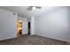 Carpeted bedroom features neutral walls, ceiling fan, and en-suite bathroom access at 2325 Windmill Pkwy # 1313, Henderson, NV 89074