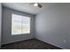 Bedroom featuring neutral walls, carpeted floors, ceiling fan, and bright window at 2325 Windmill Pkwy # 1313, Henderson, NV 89074