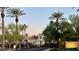 Gated community entrance with lush greenery and palm trees, offering security and a picturesque setting at 2325 Windmill Pkwy # 1313, Henderson, NV 89074