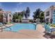 Inviting community pool with lounge chairs and lush landscaping, creating a perfect space for relaxation and leisure at 2325 Windmill Pkwy # 1313, Henderson, NV 89074