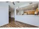 Inviting living room with hardwood floors and a view of the kitchen featuring white appliances at 2325 Windmill Pkwy # 1313, Henderson, NV 89074