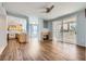 Spacious living room with modern fireplace, wood floors, ceiling fan, and open kitchen concept, great for gatherings at 2325 Windmill Pkwy # 1313, Henderson, NV 89074