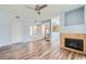 Cozy living room features a fireplace, wood floors, ceiling fan, with views to the entrance and kitchen area at 2325 Windmill Pkwy # 1313, Henderson, NV 89074