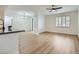 Open living room featuring wood flooring, plantation shutters, and a ceiling fan at 2325 Windmill Pkwy # 811, Henderson, NV 89074