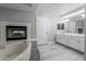 Bright primary bathroom with a fireplace and jacuzzi tub at 2528 Furnace Creek Ave, Henderson, NV 89074