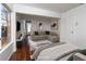 Cozy bedroom featuring a plush sectional, wood floors, and lots of natural light from the window at 2528 Furnace Creek Ave, Henderson, NV 89074