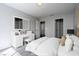 This staged bedroom features a dressing table, a comfortable bed, and neutral colors at 2528 Furnace Creek Ave, Henderson, NV 89074