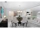 Bright dining area with elegant chandelier and seating for six, perfect for entertaining guests at 2528 Furnace Creek Ave, Henderson, NV 89074