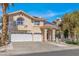 Charming two-story home with arched window, three car garage, and manicured landscaping at 2528 Furnace Creek Ave, Henderson, NV 89074