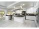 Bright kitchen with white cabinetry, stainless steel appliances, and a large island, perfect for cooking at 2528 Furnace Creek Ave, Henderson, NV 89074