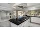 Modern kitchen with a large island, sleek appliances, and bright lighting, perfect for culinary enthusiasts at 2528 Furnace Creek Ave, Henderson, NV 89074