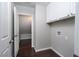 Well-lit laundry room with white cabinets, tile floors, and convenient washer/dryer hookups at 2528 Furnace Creek Ave, Henderson, NV 89074