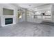 Spacious living room with a fireplace and sliding glass doors leading to the outdoor area and kitchen at 2528 Furnace Creek Ave, Henderson, NV 89074