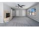 Spacious living room with a fireplace, and bright windows at 2528 Furnace Creek Ave, Henderson, NV 89074