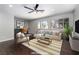 Staged living room with stylish furniture, modern decor, and great natural light at 2528 Furnace Creek Ave, Henderson, NV 89074