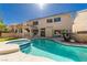 Gorgeous backyard featuring a sparkling pool, jacuzzi, covered patio, and lush landscaping at 2528 Furnace Creek Ave, Henderson, NV 89074
