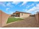 The backyard has a covered patio, turf area, and desert landscaping for low-maintenance living at 3018 Carothers Ct, North Las Vegas, NV 89032