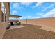 Spacious backyard features a covered patio area with desert landscaping and privacy fence at 3018 Carothers Ct, North Las Vegas, NV 89032