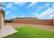 Desert landscaping with turf section and privacy fence is displayed in this backyard at 3018 Carothers Ct, North Las Vegas, NV 89032