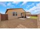 This home's backyard has desert landscaping, partial turf, and a covered patio for outdoor enjoyment at 3018 Carothers Ct, North Las Vegas, NV 89032