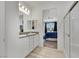 Bright bathroom with double vanity sinks and view of the bedroom, shower, and walk-in closet at 3018 Carothers Ct, North Las Vegas, NV 89032