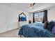 This bedroom features a ceiling fan, neutral carpet, black-out curtains and a dresser with a TV at 3018 Carothers Ct, North Las Vegas, NV 89032