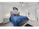 Stylish bedroom with plush blue comforter, decorative headboard, and neutral carpet at 3018 Carothers Ct, North Las Vegas, NV 89032