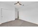 This bedroom offers neutral carpet, white walls, closet and ceiling fan at 3018 Carothers Ct, North Las Vegas, NV 89032