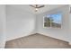 A bright bedroom with carpet, ceiling fan, and a window for lots of natural light at 3018 Carothers Ct, North Las Vegas, NV 89032