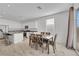 Open floor plan with dining area adjacent to the kitchen, featuring white cabinetry and island seating at 3018 Carothers Ct, North Las Vegas, NV 89032